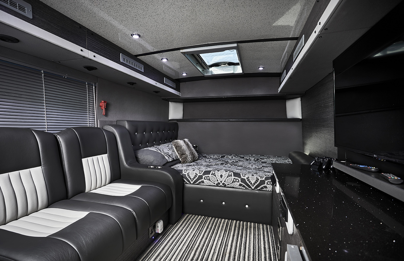 On-board our UK sleeper buses, inside the star sleeper bus private room for the artist. Double bed with plush seating area and HD TV. 