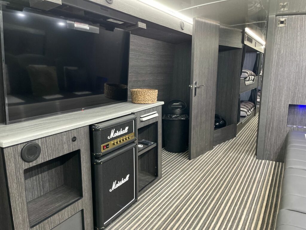 Interior of our Premium Sleeper buses. TV and Speaker with storage space.