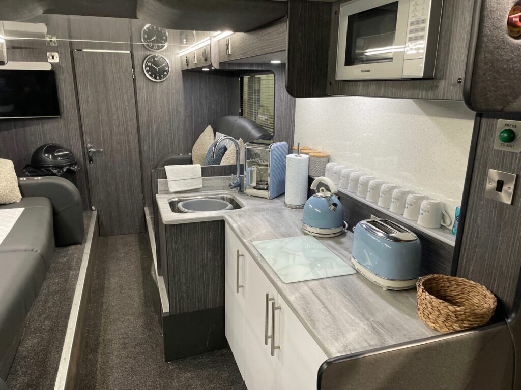 On-board our band sleeper bus. Kitchen with amenities. 
