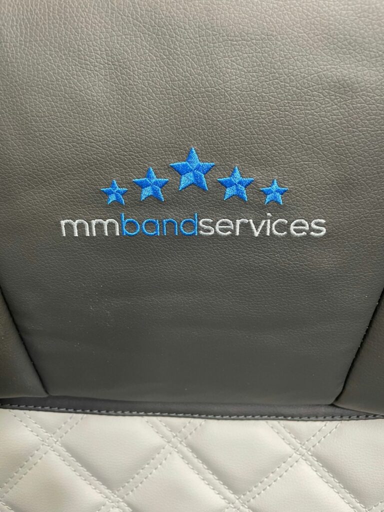 MM Band Service logo on comfy seating area in our sleeper buses. 