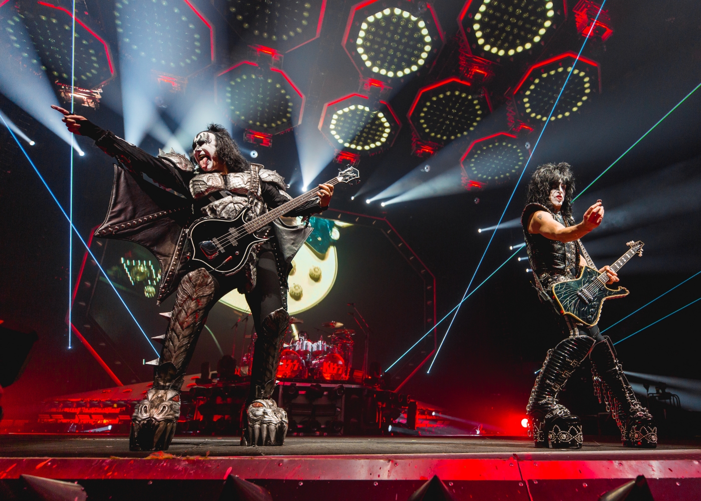 Two members of band 'KISS' on stage with makeup and theatrical rock outfits